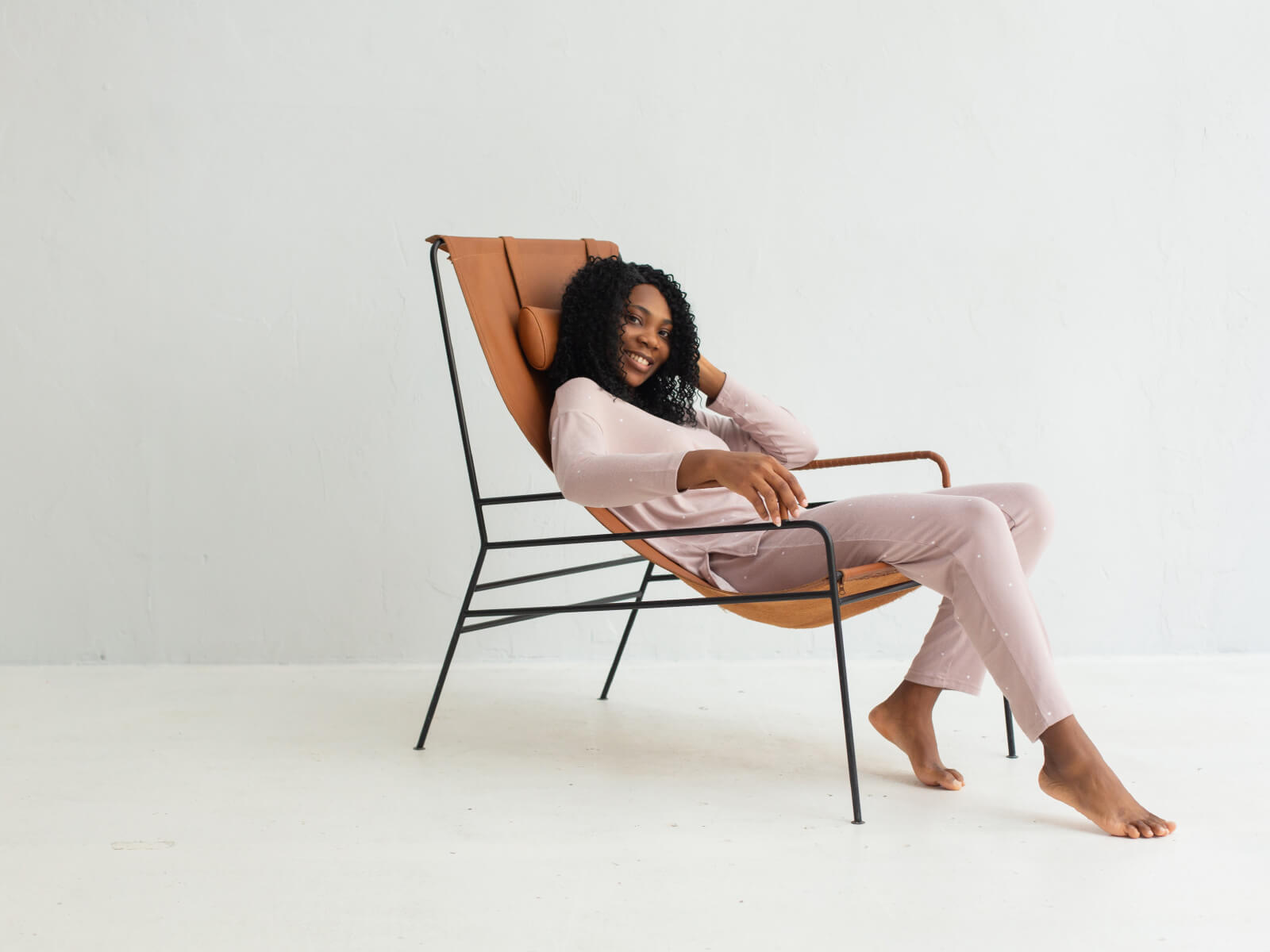 A woman sitting in a chair with her legs crossed.