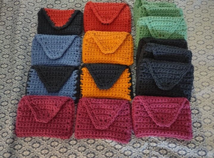 A group of crocheted purses in different colors.