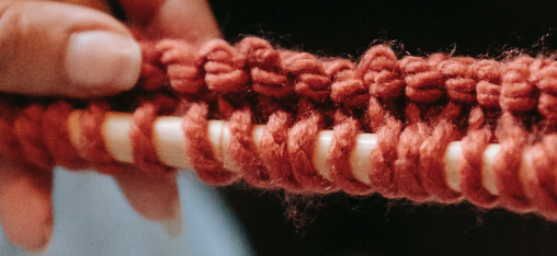 A close up of the end of a knitted scarf