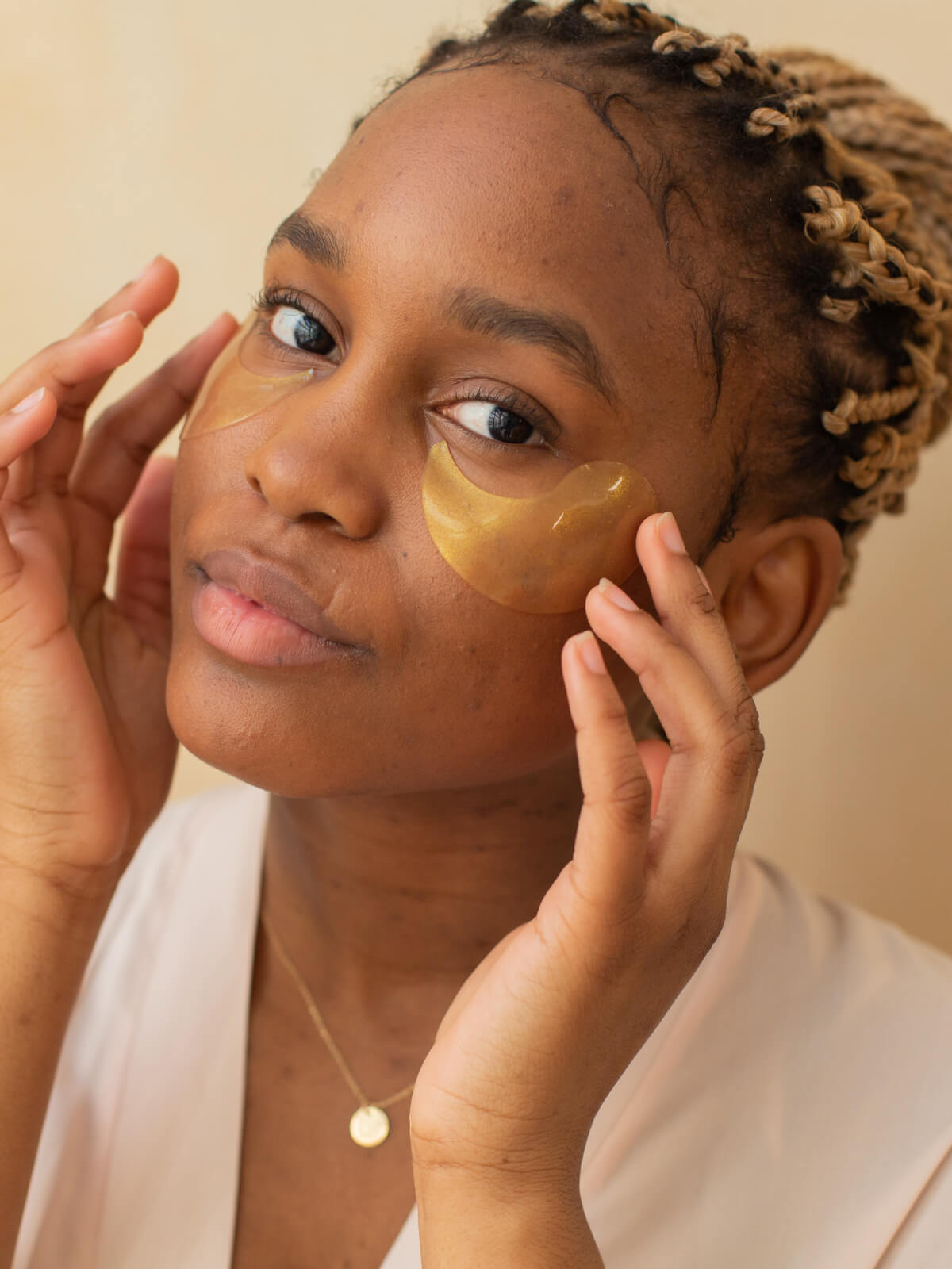 A woman with a gold face mask on her face.