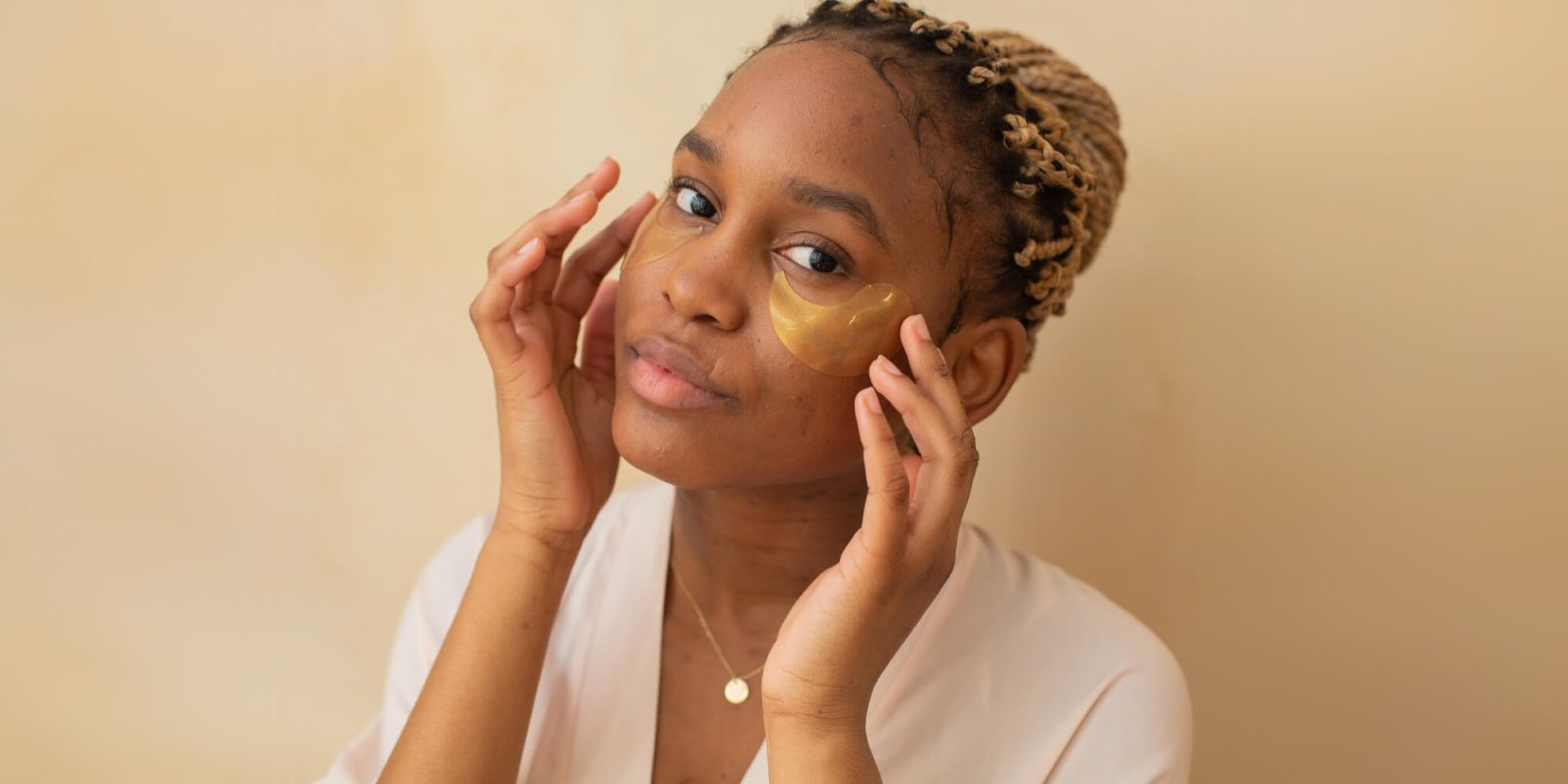 A woman with a gold eye shadow on her face.